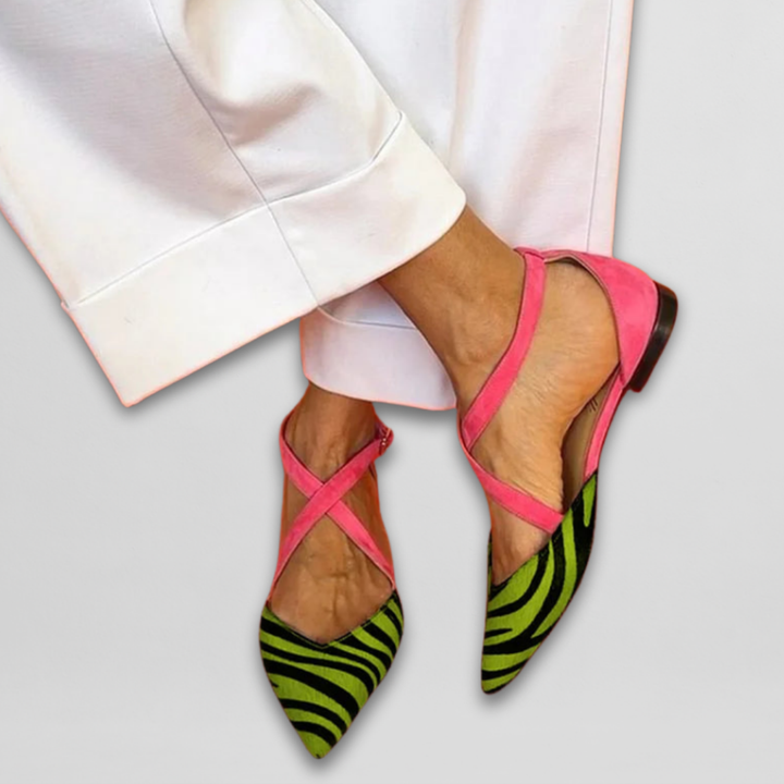 Stylish women's ballet flats featuring a pointed toe and elegant zebra print strap. Comfortable chic shoes.