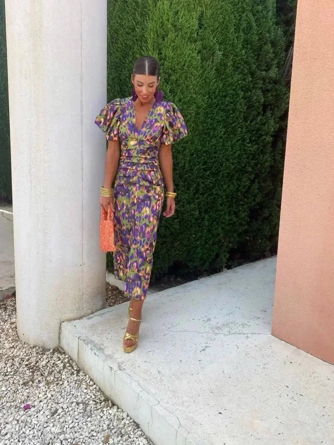 Chic women's printed maxi wedding guest dress featuring V-neck, puff sleeves, & ruched waist. Stylish evening formal wear.