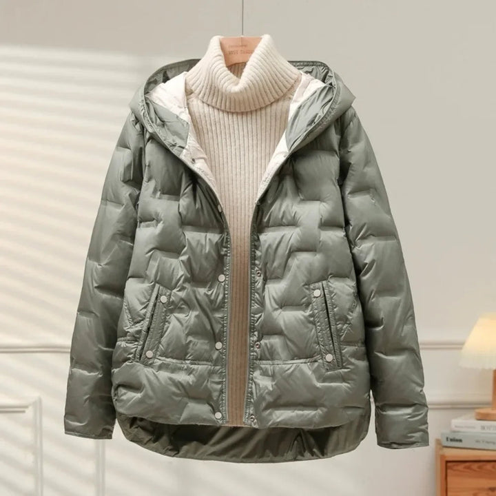 Close-up of the quilted pattern on a women's warm puffer jacket, highlighting winter warmth & style.