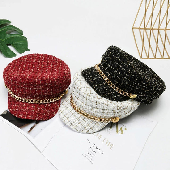 Women's chic red cotton tweed cap with elegant gold chain, a stylish fashion accessory.
