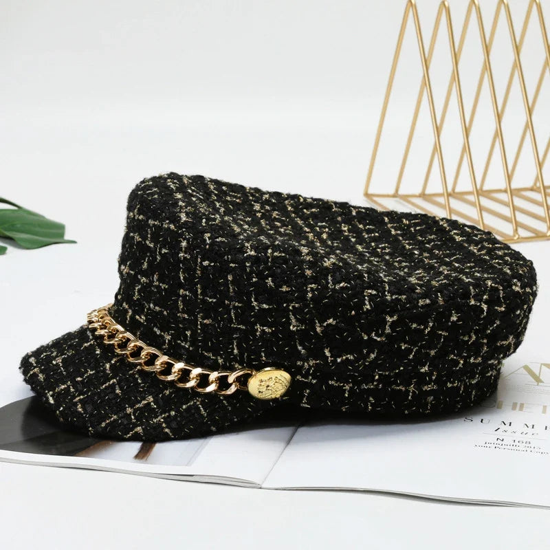 Black structured cotton tweed women's cap, adorned with a sophisticated gold chain.