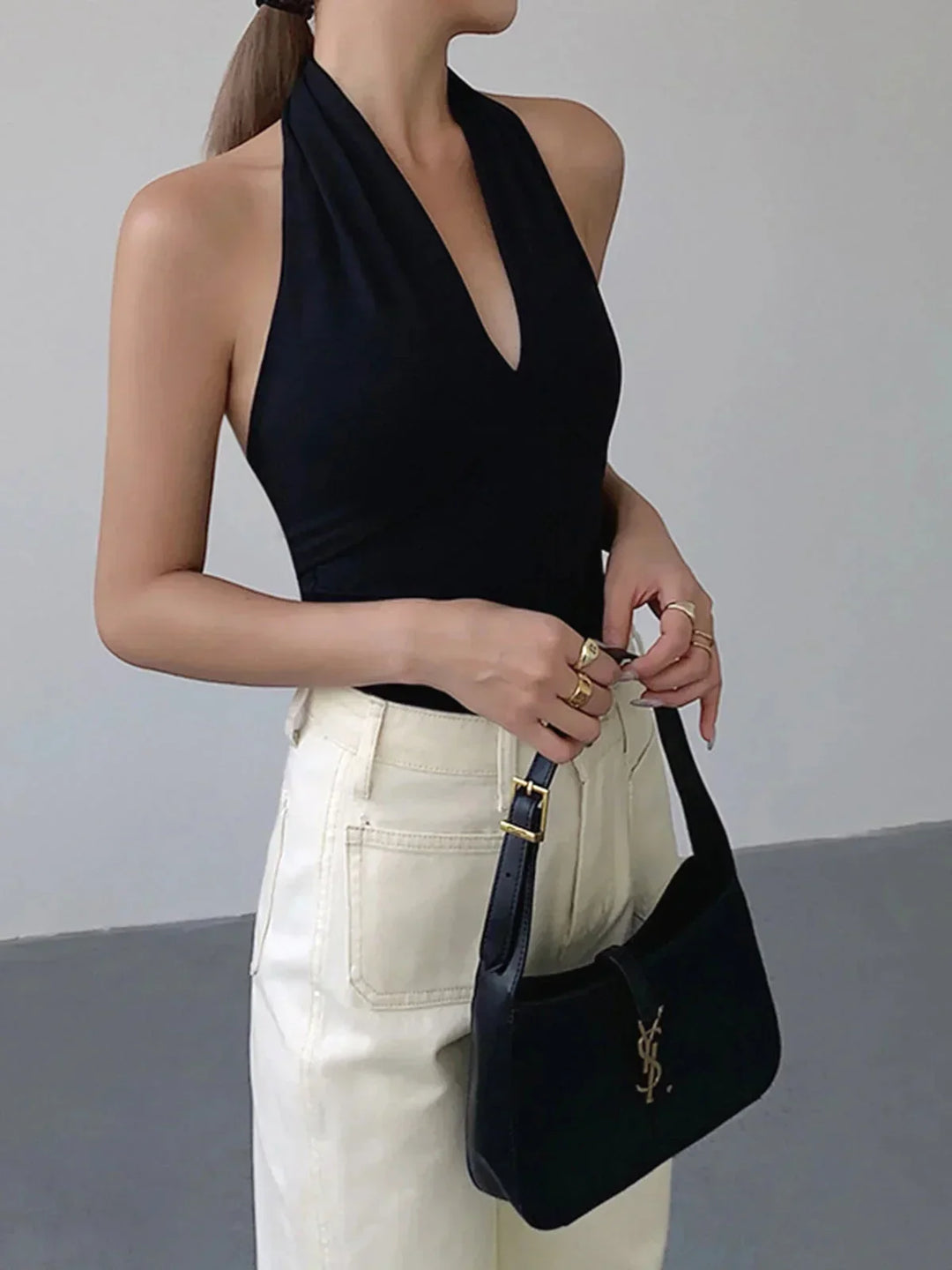 Elegant women's knit halter top, sleeveless with stylish crossover V-neck, versatile for casual summer fashion.