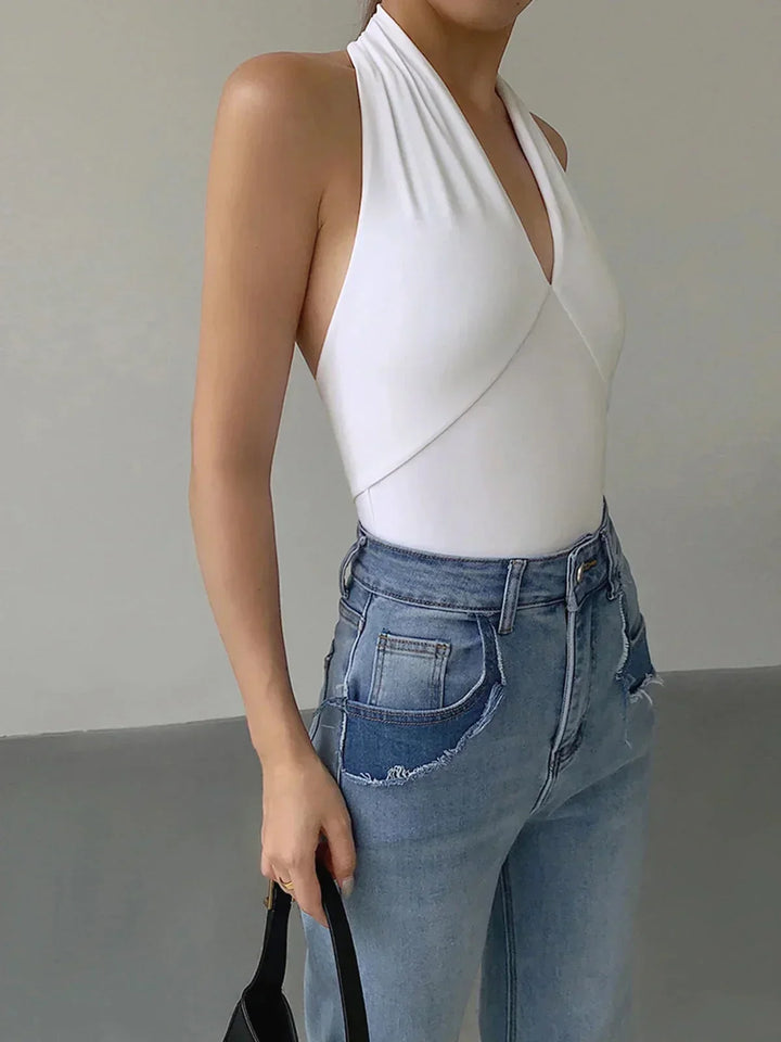 Chic women's sleeveless halter top with crossover V-neck, a versatile slim-fit knit for summer.