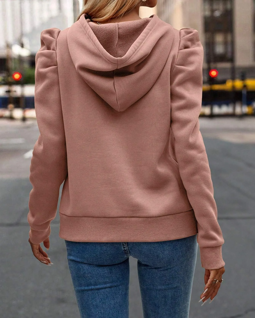 Fashionable women's stacked sleeve hoodie with ruched shoulders, a chic layered look.
