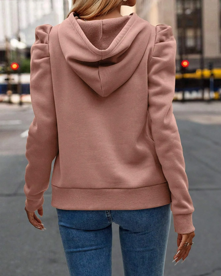 Fashionable women's stacked sleeve hoodie with ruched shoulders, a chic layered look.