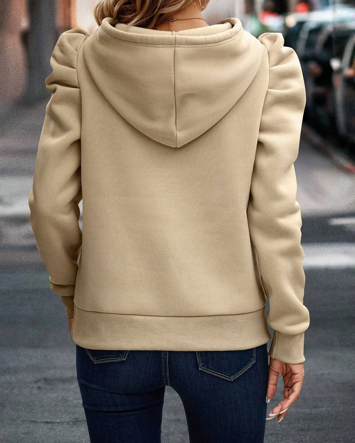 Close-up of stacked sleeve on a women's chic hoodie, highlighting ruched shoulder design.