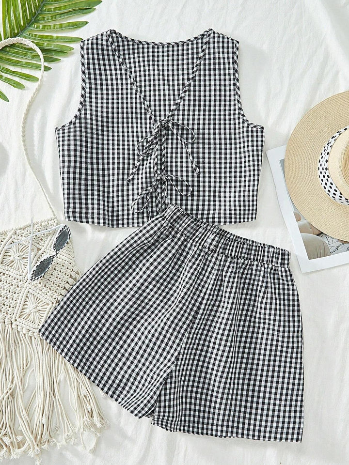 Stylish women's striped lounge set with crop top & shorts, versatile for home or casual outings.