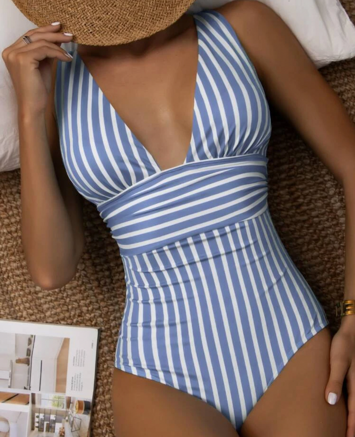 Chic women's striped one-piece swimsuit, flattering beachwear for summer, a comfortable vacation essential.
