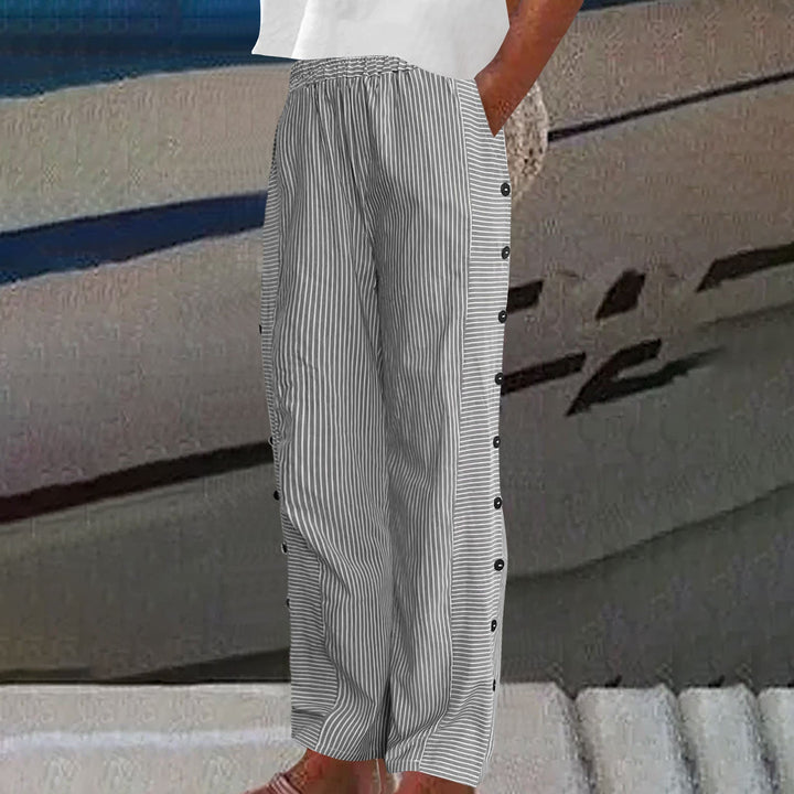 Close-up of the elegant button accent detail on comfortable women's striped pants, ideal for chic summer fashion.