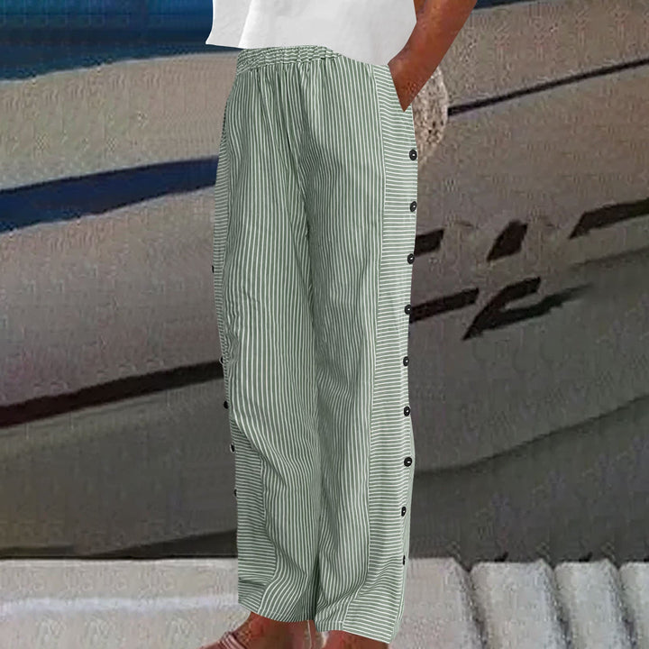 Full length view of relaxed fit women's striped pants. Casual, comfortable, and chic with stylish button details.