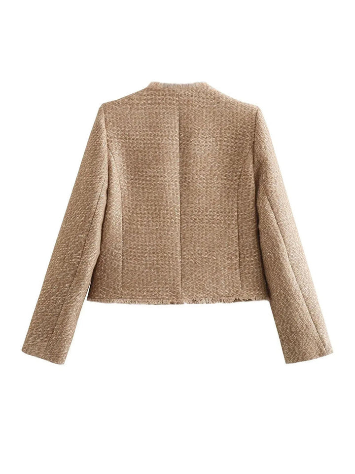 Classic women's tweed jacket, a chic fashion statement. Features elegant gold buttons and a stylish design.