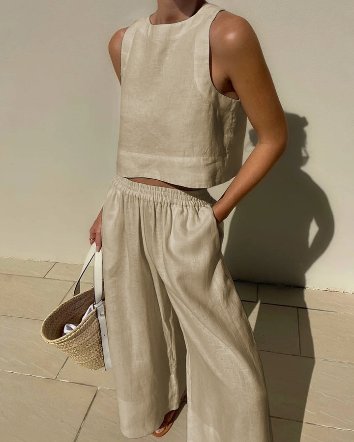Elegant women's two-piece crop top and wide-leg pant set in a chic design. A stylish summer fashion ensemble.