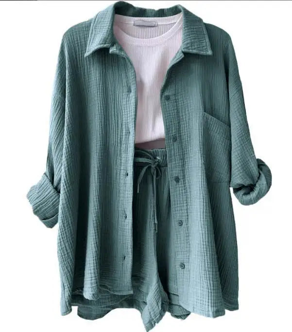 Stylish women's beach outfit: button-up shirt and matching drawstring shorts, perfect for seaside.