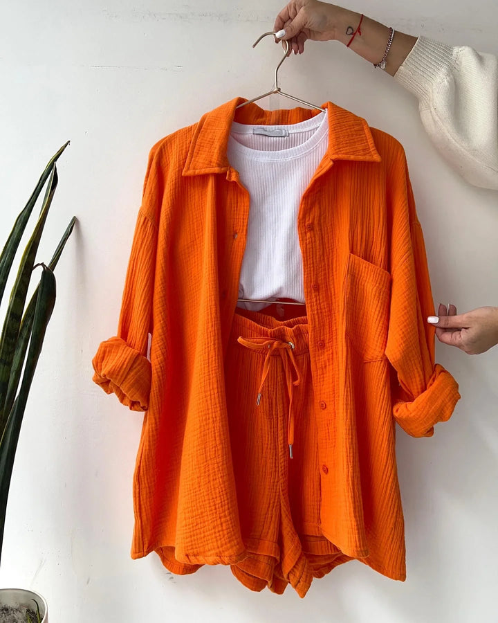 Vibrant women's matching shorts set, featuring a relaxed button-up shirt and comfy drawstring shorts.