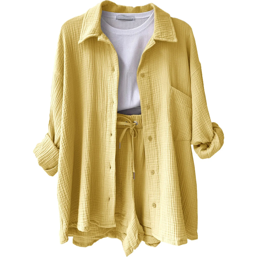 Women's casual summer outfit: loose-fit button-up shirt & comfortable elastic-waist shorts.
