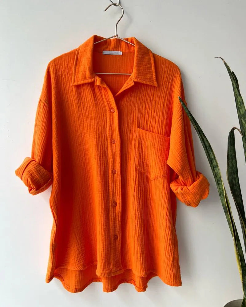 Casual summer loungewear: women's two-piece set with stylish button-up shirt and elastic shorts.