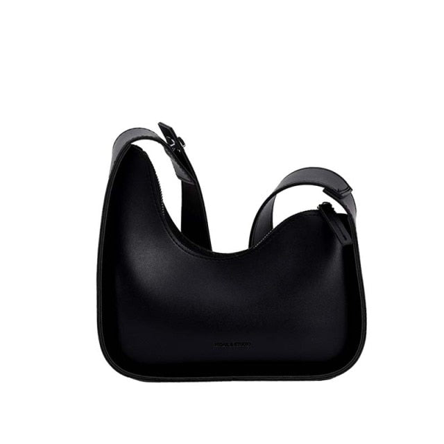 Elegant black women's shoulder bag with unique wave design, a versatile PU leather handbag.