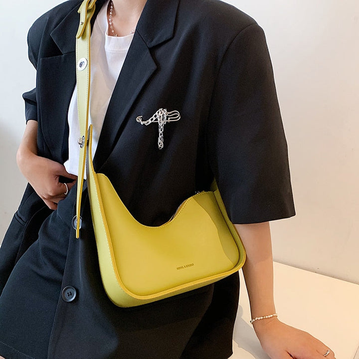 Fashionable women's PU leather shoulder bag with unique wave design, a versatile chic handbag accessory.