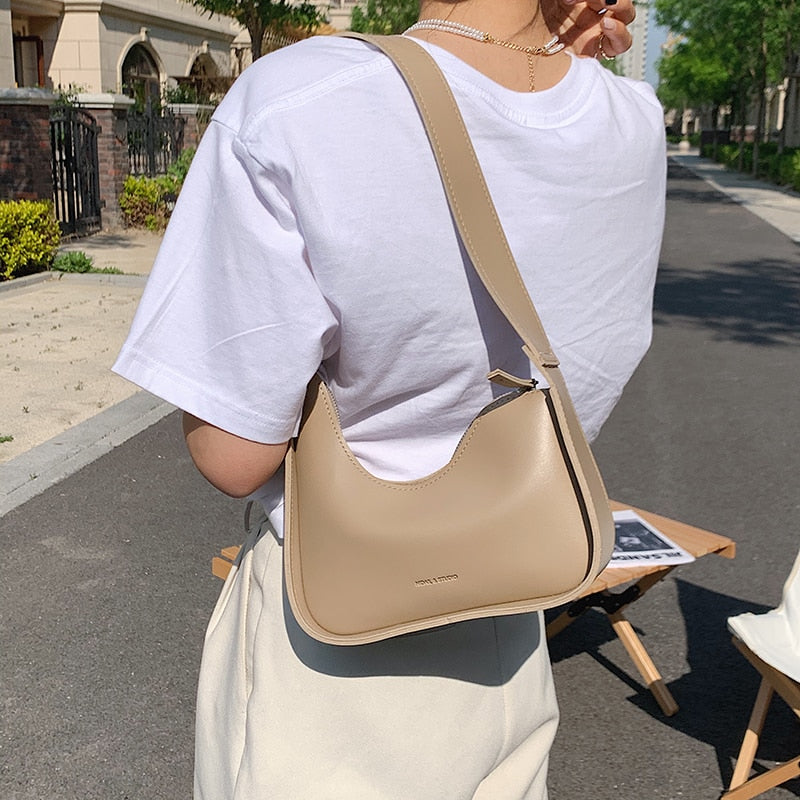 Close-up of the textured PU leather and chic wave design on this women's versatile shoulder bag.