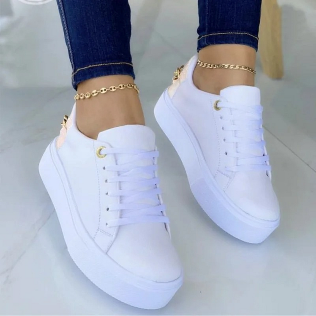 Supportive white women's sneakers with a chic metal chain detail, combining comfort with modern fashion for daily wear.