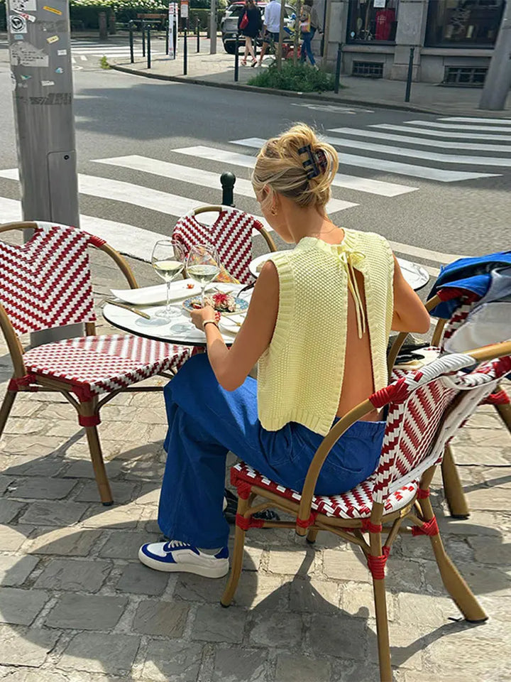 Lightweight yellow knit top for women, sleeveless and chic. Ideal for summer fashion, casual yet elegant with a round neck.