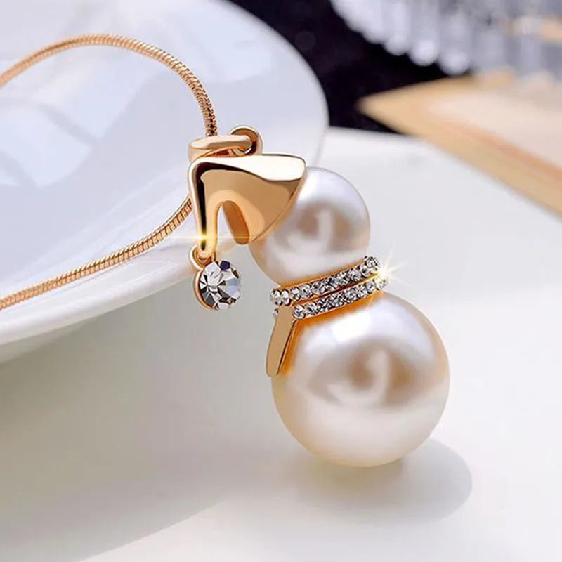Sparkling silver Christmas snowman pearl necklace. A festive women's accessory for holiday fashion.