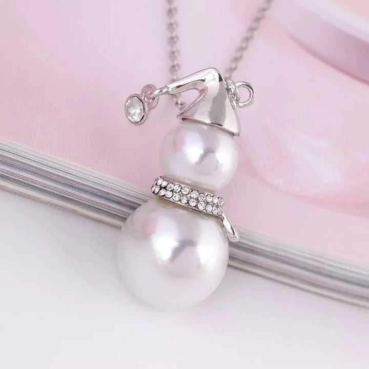 Close-up of a charming Christmas snowman pearl necklace. Perfect elegant holiday jewelry for women.