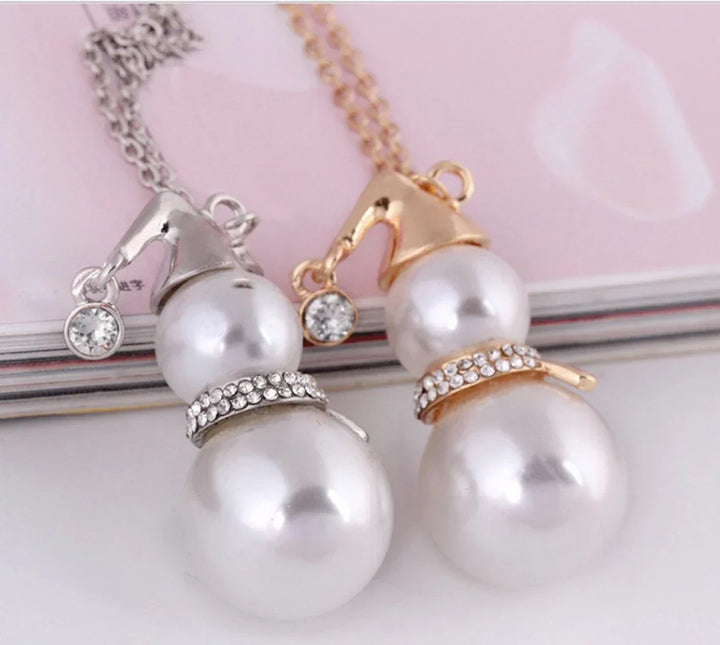 Woman showcasing a festive Christmas snowman pearl necklace, ideal winter fashion accessory.