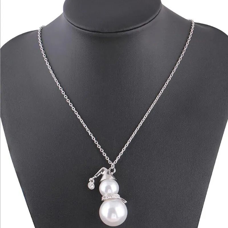 Festive snowman pearl necklace with dainty pearls. A charming women's accessory for holiday cheer.