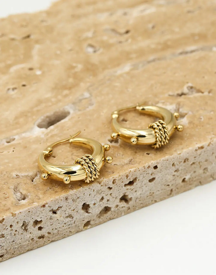 Women's chunky Bali hoop earrings, available in radiant gold and sleek silver, perfect statement jewelry.