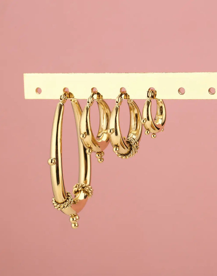 Detailed chunky Bali hoop earrings for women, a unique gold or silver jewelry statement piece.