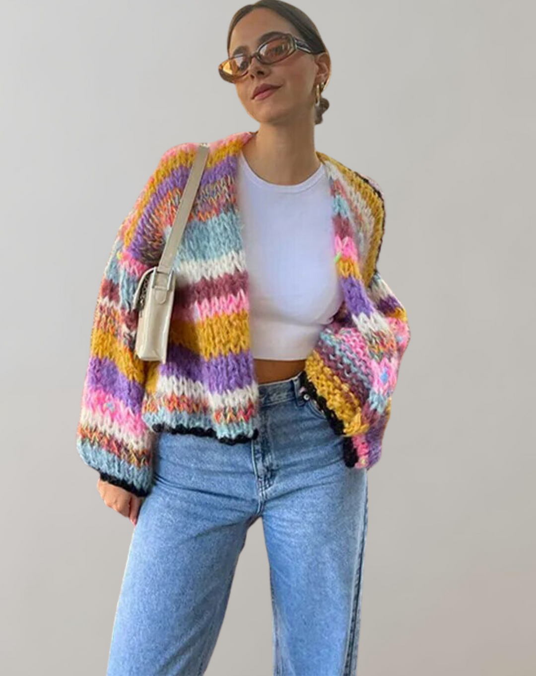 Woman wearing a colorful open front chunky knit Lotta cardigan, styled for comfortable winter layering