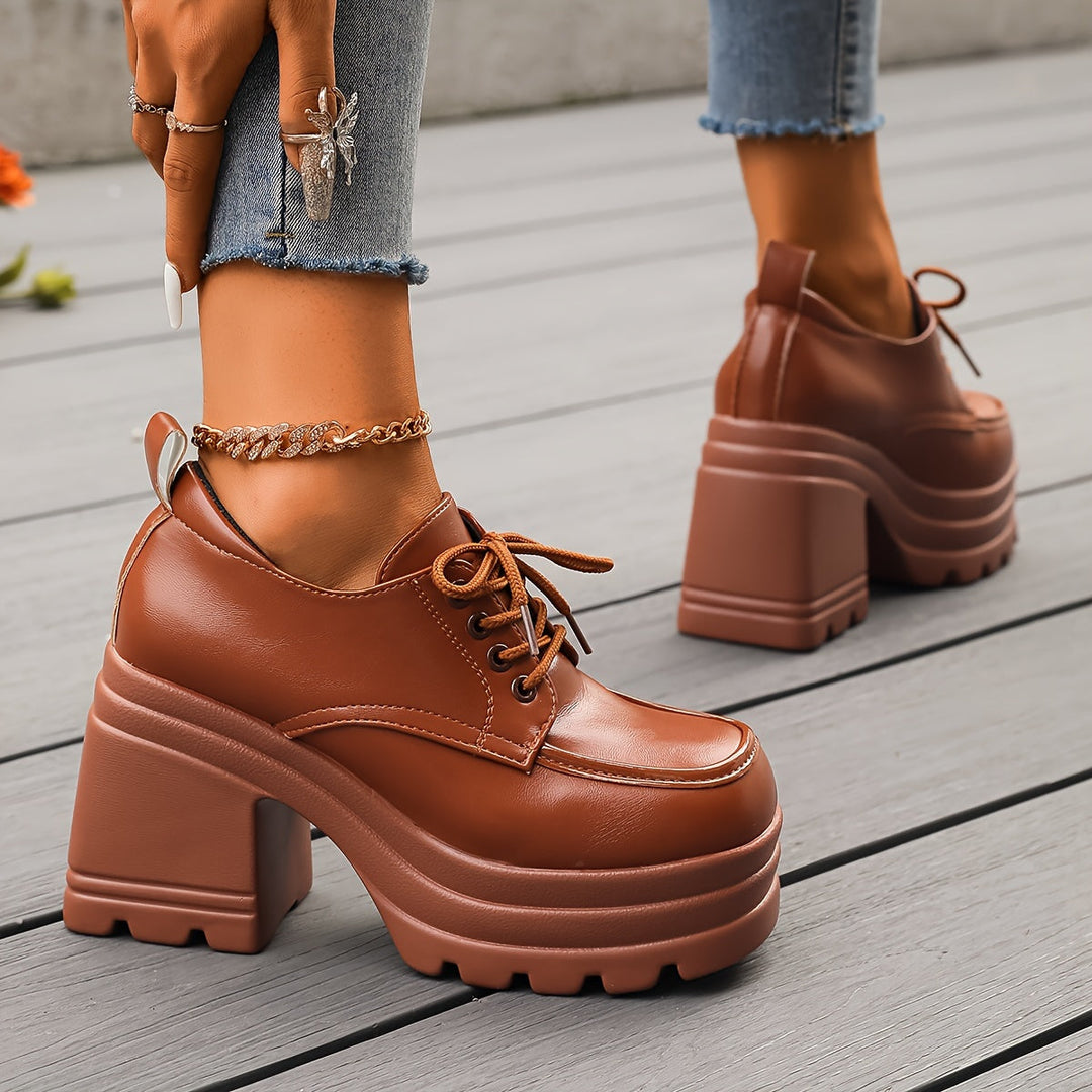 Fashionable women's chunky platform oxfords, featuring lace-up design and retro comfort.