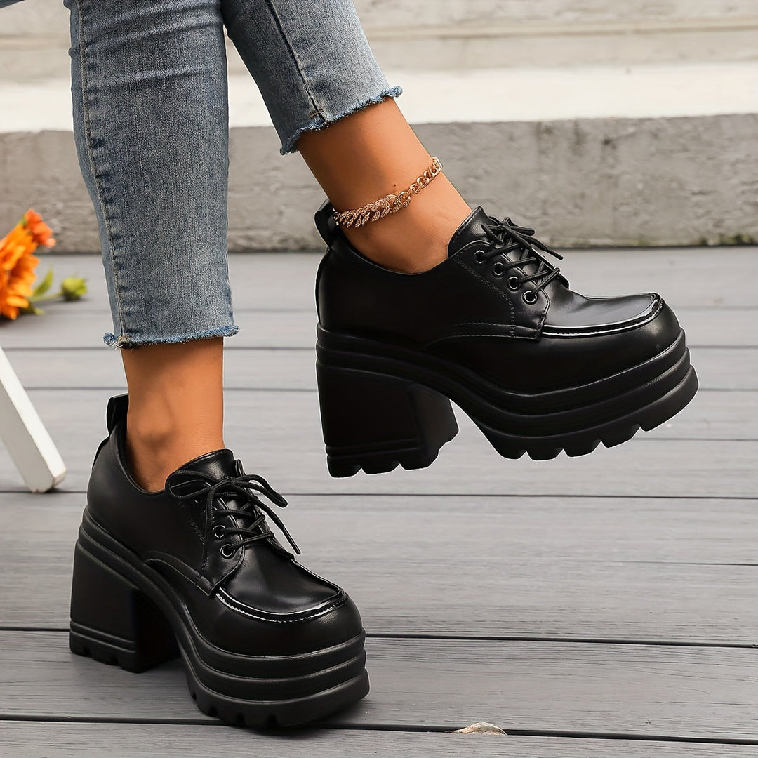 Retro-style women's platform oxfords with chunky heels and lace-up closure, designed for comfortable fashion.