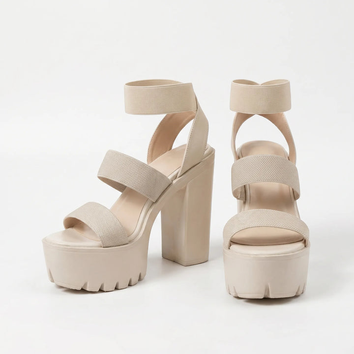 Beige women's slip-on platform sandals with chunky heels, offering comfortable and casual summer style.