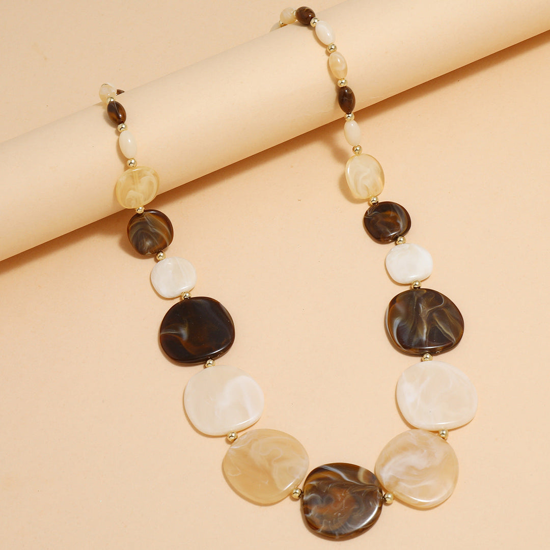 Close-up of a women's chunky wooden bead statement necklace. Natural, large wooden beads, earthy tones, bohemian fashion.