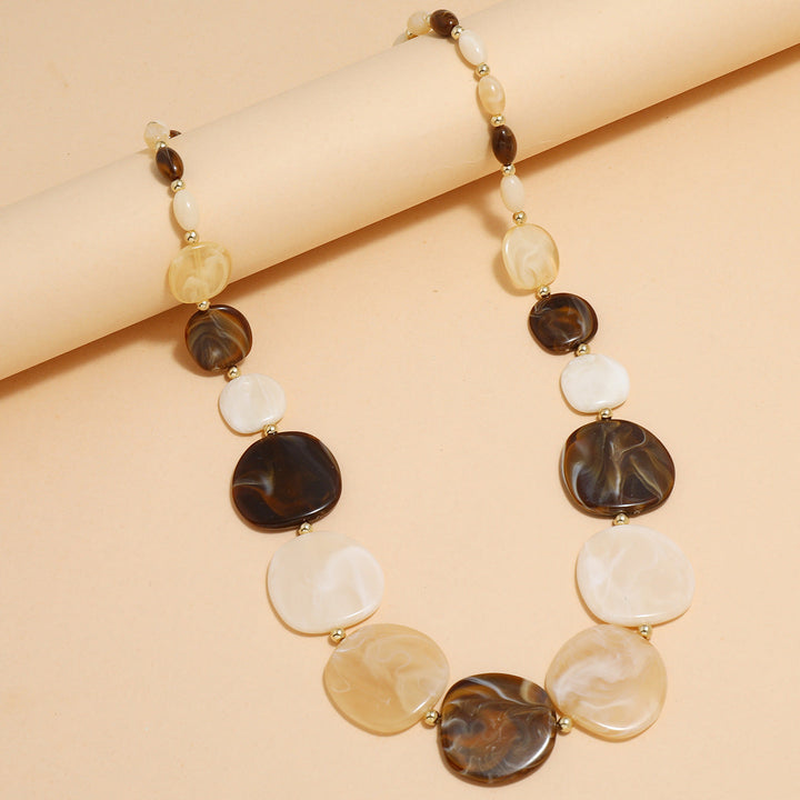 Close-up of a women's chunky wooden bead statement necklace. Natural, large wooden beads, earthy tones, bohemian fashion.