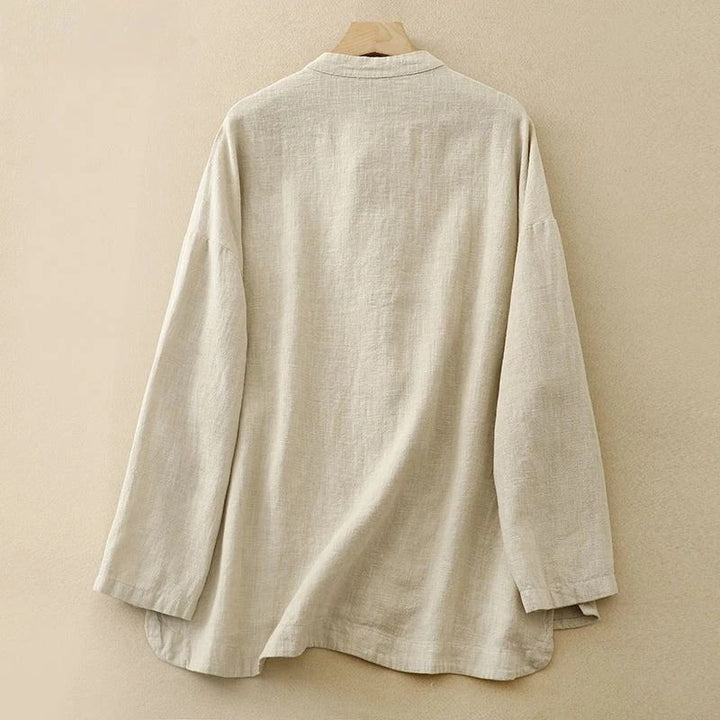 Versatile women's button-front shirt, a sophisticated classic with distinctive knot closures & long sleeves.