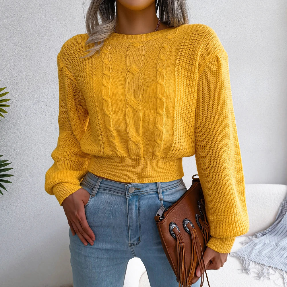 Women's classic cable knit sweater in cozy yellow. Relaxed fit, perfect for casual winter fashion.