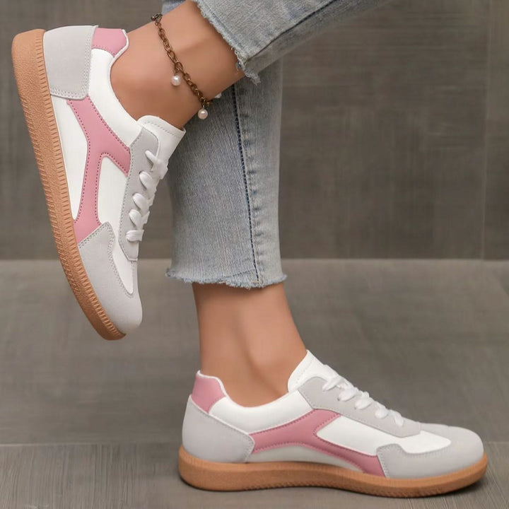 Pink low-profile women's fashion sneakers, offering casual comfort & versatile everyday wear.