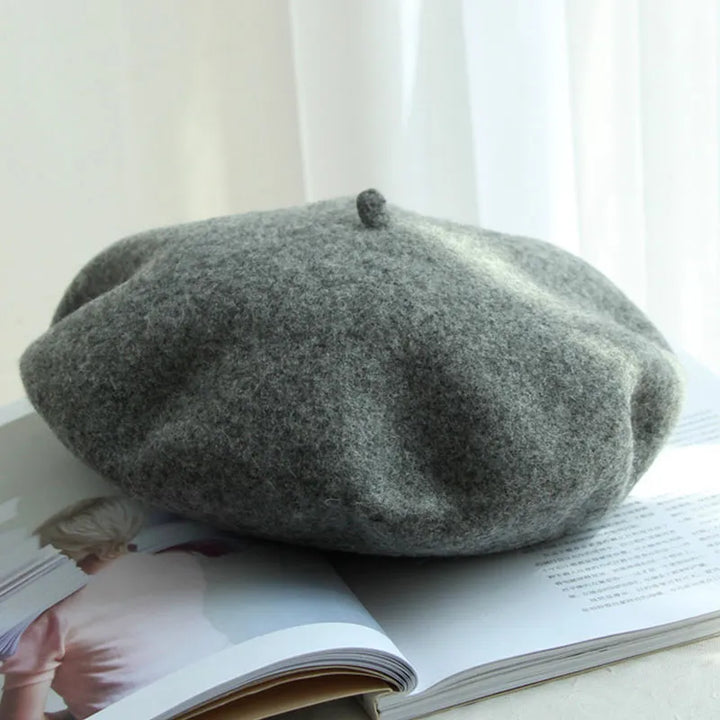 Chic women's cream wool beret, an elegant and cozy winter headwear accessory.