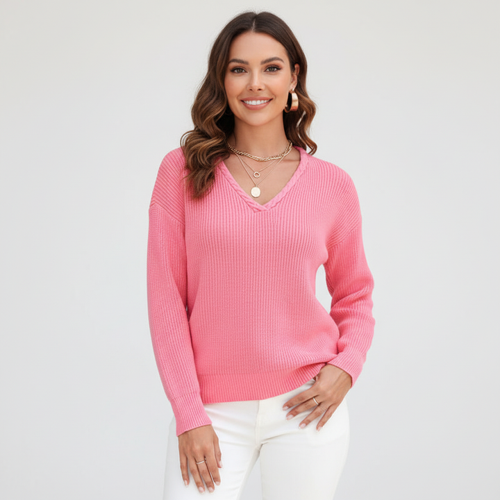 Full shot of a women's long sleeve V-neck knit pullover, highlighting its relaxed fit.