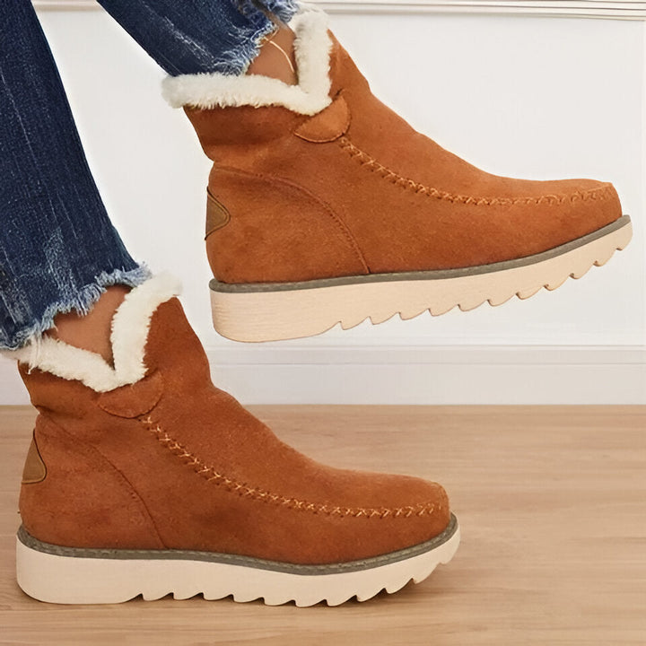 Durable women's non-slip snow booties. Warm winter ankle boots designed for comfort, grip, and cold weather.
