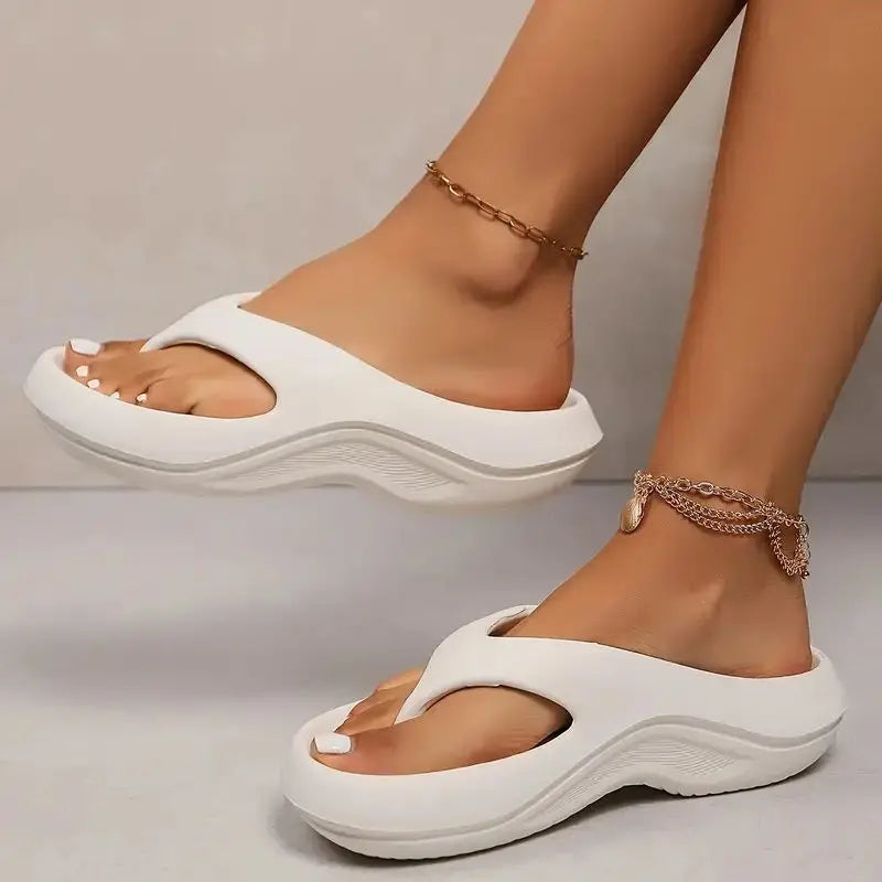 Women's cushioned platform flip flops offering arch support & non-slip grip. Great for summer comfort.
