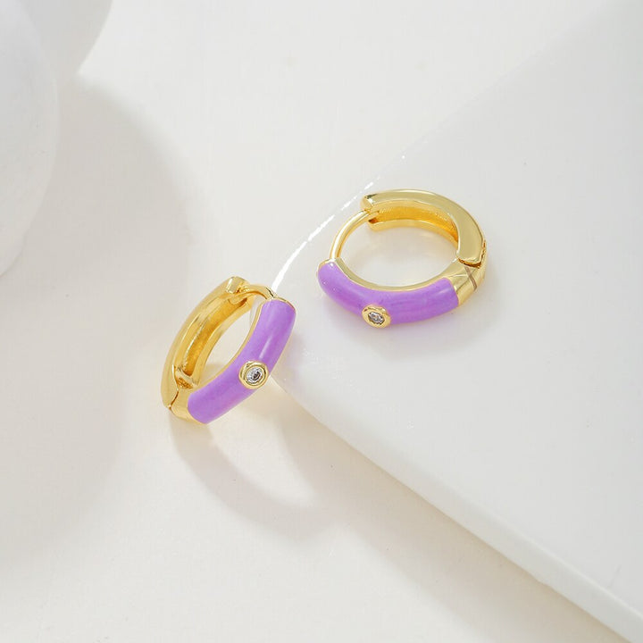 Close-up of stylish colorful earcandy earrings for women, gold-plated, vibrant fashion accessories.
