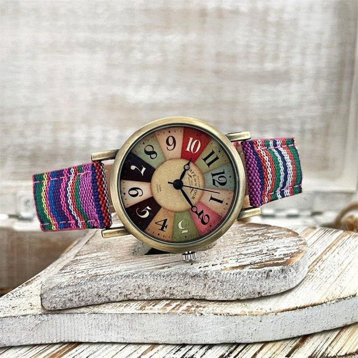 Detailed view of a women's colorful rainbow watch with a sophisticated braided strap, a vintage touch