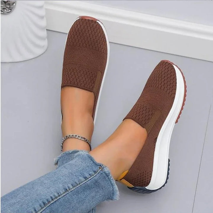 Comfortable women's slip-on walking shoes, featuring a soft breathable knit for everyday wear and flexibility.