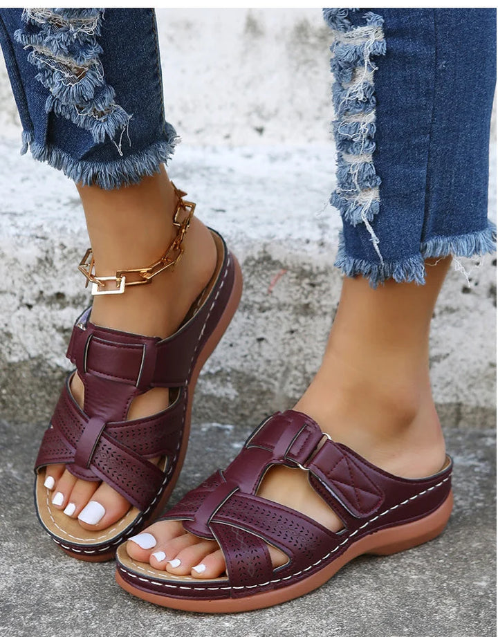 Woman walking in stable orthopedic sandals, ideal comfort footwear for an active lifestyle.