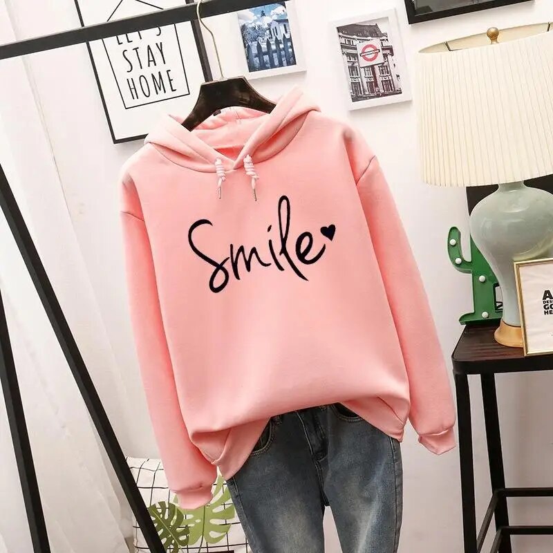 Cozy women's graphic hoodie featuring a cheerful smile design, perfect for casual, relaxed style.
