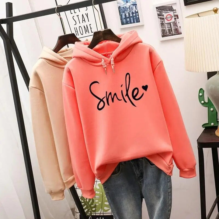 Happy women's smile graphic pullover hoodie, ultimate comfort wear for positive and relaxed fashion.